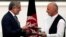 Afghan rival presidential candidates Ashraf Ghani (R) and Abdullah Abdullah and exchange signed agreements for the country's unity government in Kabul Sept. 21, 2014.