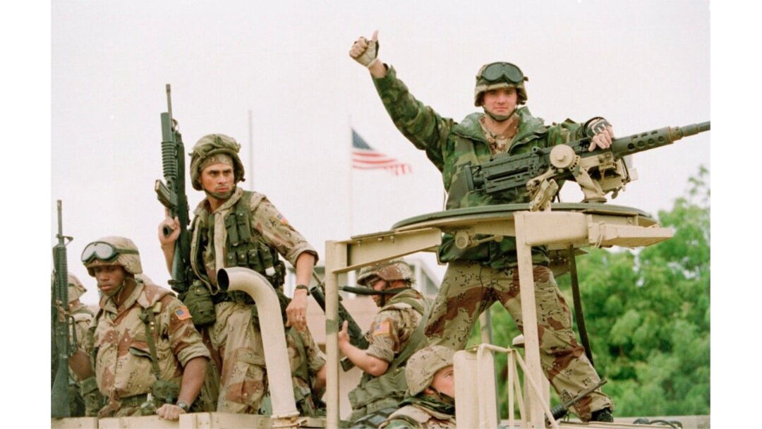 FILE - A U.S. Marine gives the thumbs up as a truckload of troops arrive at the U.S. Embassy in Mogadishu, Somalia, Dec. 10, 1992.