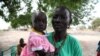 Members say the bank has made it possible to pay for their children's education and medical fees, Rumbek, Lakes State, South Sudan, Jan. 30, 2013. (H. McNeish/VOA)