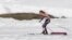 United States' Sophie Caldwell skis with a sleeveless top as temperatures went well over the freezing point during the women's 10K classical-style cross-country race at the 2014 Winter Olympics, Feb. 13, 2014.