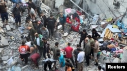 FILE—Palestinians search for casualties at the site of Israeli strikes on houses in Jabalia refugee camp, amid the ongoing conflict between Israel and Hamas, at the Indonesian hospital, in the northern Gaza Strip November 18, 2023.