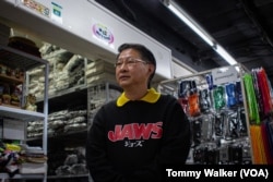 Ben’s Socks store owner Banchob Pianphanitpor says his business has seen sales reduce by half since low quality imports came into Thailand from China, in Bangkok, Dec. 17, 2024.