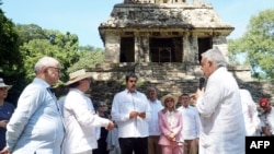 This handout picture released by the Mexican Presidency shows Mexican President Andres Manuel Lopez Obrador, right, speaking to Venezuelan President Nicolas Maduro, center, and Colombian President Gustavo Petro during the migration summit, Chiapas state, Mexico, Oct. 22, 2023.