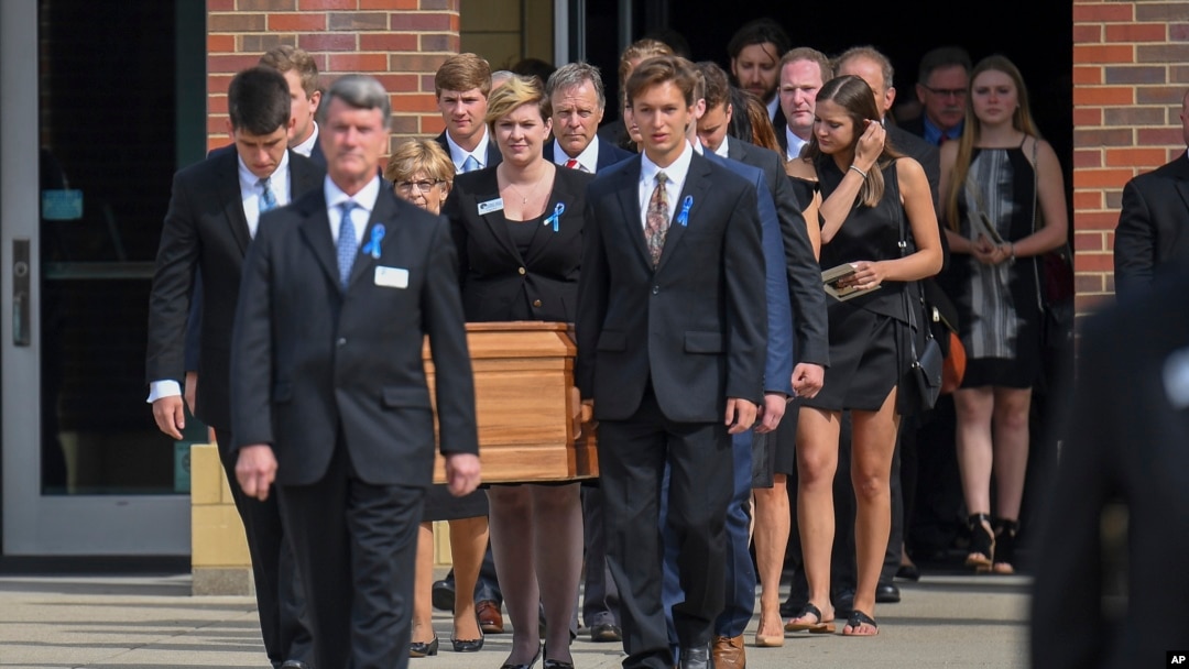 The casket of Otto Warmbier is carried from Wyoming High School after his funeral, June 22, 2017.