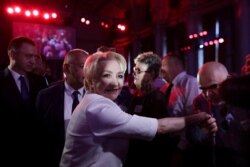 A man kisses the hand of Romania's Prime Minister Viorica Dancila while she arrives at a party congress organised by the ruling Social Democrats (PSD) in Bucharest, Romania, Aug. 24, 2019.