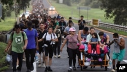 FILE - Migrants walk along the Huixtla highway in the state of Chiapas, Mexico, Oct. 22, 2024, hoping to reach the country's northern border and ultimately the United States.