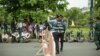 FILE - A traffic police officer takes a drink of water while being dispatched to guard outside the Supreme Court building in Phnom Penh, Cambodia, on August 22, 2018. (Ty Aulissa/VOA Khmer)