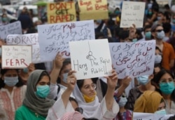 FILE - Members of civil society groups take part in a rally to condemn the incident of rape on a deserted highway, in Karachi, Pakistan, Sept. 12, 2020.