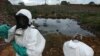 Waste removal experts work to extract hazardous black sludge from a garbage dump in Abidjan, Ivory Coast, September 17, 2006. (AP)