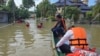 Thai rescuers offer food to flood affected people in Narathiwat province, southern Thailand, Dec. 3, 2024. 