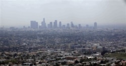 FILE - Smog from smokestacks, diesel engines, automobiles and other sources of pollution, Los Angeles, April 2009.