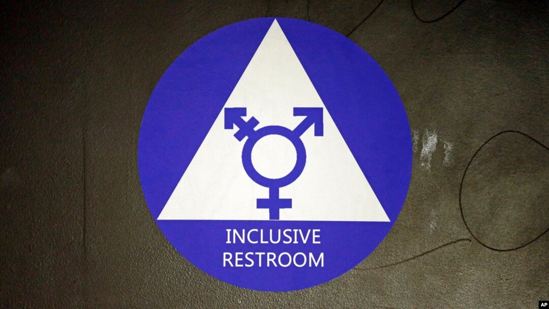 FILE - A sticker designates a gender-neutral bathroom at Nathan Hale high school in Seattle, May 17, 2016.