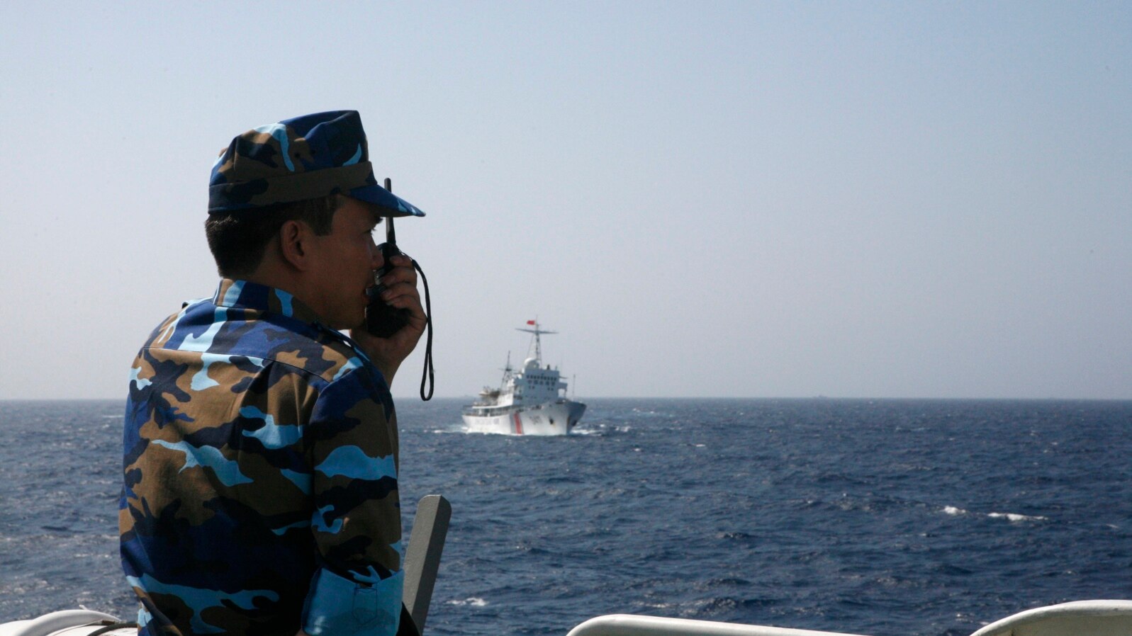 Vietnamese coast guard officer monitors Chinese vessel in the South China Sea, about 210 km (130 miles) off coastal Vietnam, May 15, 2014.