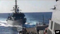 This photo provided bythe U.S. 5th Fleet shows a Russian Navy ship approaching an American warship in the North Arabian Sea, Jan. 9, 2020.