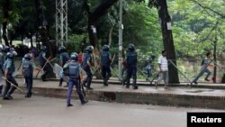 Students run after clashes with the police during a protest over recent traffic accidents that killed a boy and a girl, in Dhaka, Bangladesh, Aug. 5, 2018. A vehicle carrying the U.S. Ambassador to Bangladesh Marcia Bernicat was attacked in the capital Dhaka on Aug. 4, 2018.