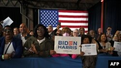 FILE—Supporters of US President Joe Biden hold signs as he speaks during a campaign event in Atlanta, Georgia, on March 9, 2024.