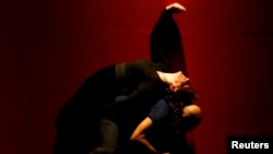 British choreographer Akram Khan and French actress Juliette Binoche (top) perform during their contemporary piece "IN-I" in Abu Dhabi January 28, 2009 as part of their global tour. 
