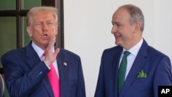 Ireland's Prime Minister Micheal Martin is greeted by President Donald Trump as he arrives at the West Wing of the White House in Washington, March 12, 2025. 