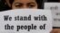 An activist affiliated with Civil Society holds a placard during a protest against Myanmar's military after seizing power from a democratically elected civilian government and arresting its leader Aung San Suu Kyi, in Kathmandu, Nepal, Feb. 1, 2021.
