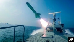 In this photo released Tuesday, July 28, 2020, by Sepahnews, a Revolutionary Guard's speed boat fires a missile during a military exercise. 