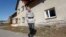 Gabriela Karp, a businesswoman, stands in front of her house in the village of Rosow, Germany, located near the Polish border, April 7, 2013. 