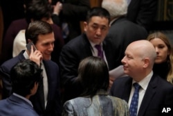 White House senior adviser Jared Kushner, left, speaks with U.S. Ambassador to the United Nations Jason Greenblatt before a meeting of the Security Council in New York, Feb. 20, 2018.