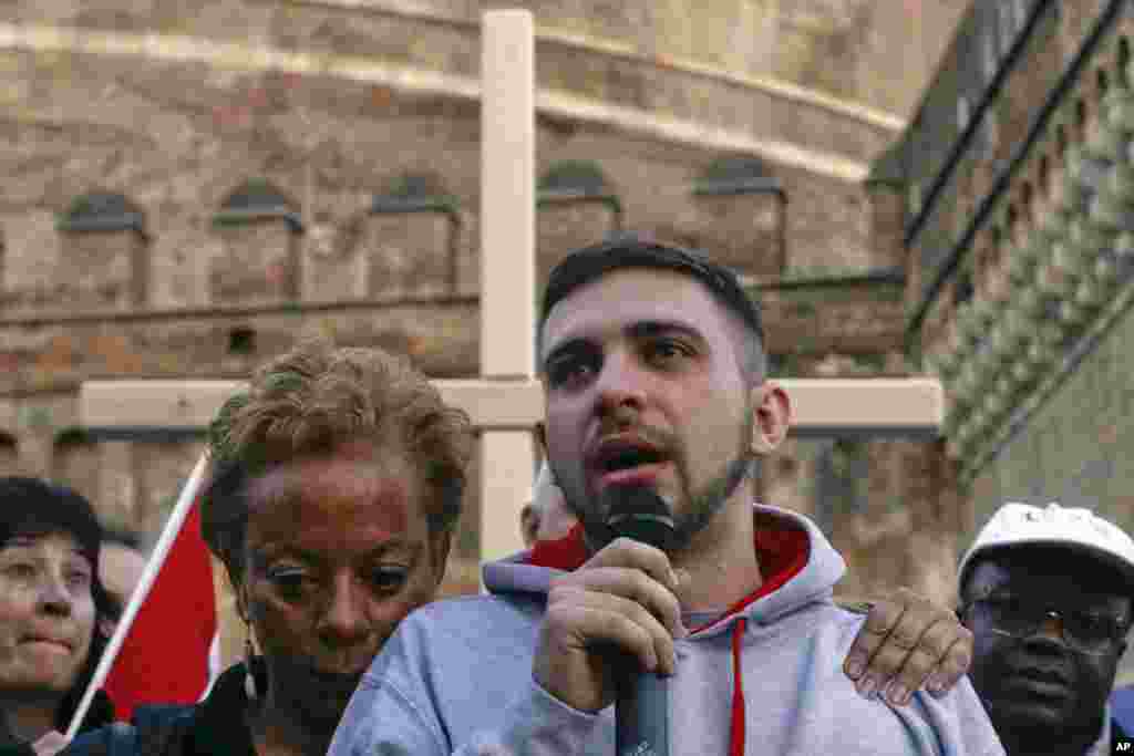 Sex abuse victim Alessandro Battaglia, right, is hugged by victim and founding member of the ECA (Ending Clergy Abuse), Denise Buchanan, as he speaks during a prayer event near Castle Sant' Angelo, in Rome, Italy.