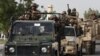 FILE - Pakistani army troops ride military vehicles following an operation launched against a terror group in Karachi, Pakistan, June 16, 2014.