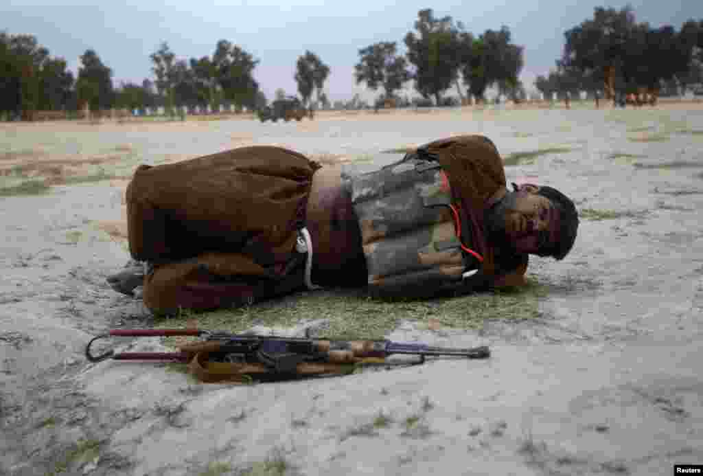 A suicide attacker lies on the ground after his vest was defused in Jalalabad province, Afghanistan. Security forces captured a would-be suicide attacker before he blew himself up.