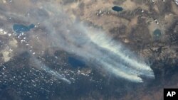 A NASA picture shows smoke from wildfires spreading across California.