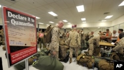 United States Marines of Fox Company, 2nd Battalion, 3rd Marine Regiment complete quarantine checks as they arrive at a Royal Australian Air Force Base in Darwin, April 4, 2012. 