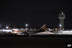 Carrying some 240 American diplomats and citizens, a Boeing 747 aircraft sits on the tarmac in Anchorage, Jan. 28, 2020. Chartered by the U.S. government, the plane flew from Wuhan, China, the source of the coronavirus outbreak.