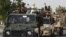 FILE - Pakistani army troops ride military vehicles following an operation launched against a terror group in Karachi, Pakistan, June 16, 2014.