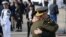 Unidentified members of the Navy embrace as they stand alongside relatives of the 44 crew members of the missing at sea ARA San Juan submarine during a ceremony to commemorate the one year anniversary of the tragedy in Mar del Plata, Argentina, Nov. 15, 2018.