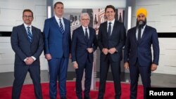 Bloc Quebecois leader Yves-François Blanchet, Conservative leader Andrew Scheer, TVA network host Pierre Bruneau, Liberal leader and Prime Minister Justin Trudeau and NDP leader Jagmeet Singh pose before a debate in Montreal, Quebec, Canada, Oct. 2, 2019.
