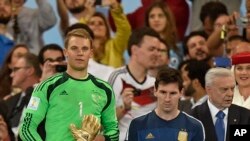 Germany's goalkeeper Manuel Neuer winner of the golden glove award for best goalkeeper stands alongside golden ball winner Argentina's Lionel Messi after the World Cup final soccer match between Germany and Argentina in Rio de Janeiro, Brazil, July 13, 20