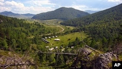 View from a rock above Denisova cave on to the excavation field camp
