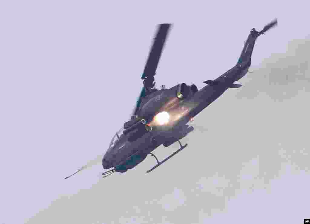 A Scout helicopter launches missiles during Han Kuang military exercises in Penghu county, Taiwan, April 17, 2013.&nbsp;