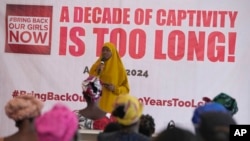 FILE—A Muslim woman prays during an event to mark the 10 years anniversary since the kidnapping of Government Girls Secondary School in Chibok by Islamist extremists, in Lagos, Nigeria, April, 14, 2024.