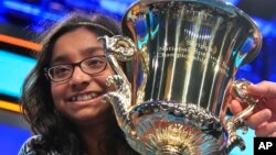 Ananya Vinay, 12, from Fresno, Calif., holds the trophy after winning the 90th Scripps National Spelling Bee, in Oxon Hill, Md., June 1, 2017.