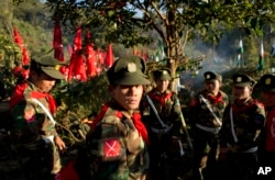 FILE - Officers with the Ta’ang National Liberation Army gather in the steep hillside jungles in Mar Wong, a village in northern Shan state, Myanmar.