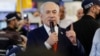 Israeli Prime Minister Benjamin Netanyahu meets members of the public in Ramla (Reuters)
