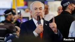 Israeli Prime Minister Benjamin Netanyahu meets members of the public in Ramla (Reuters)
