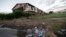 A pile of garbage sits in front of an abandoned section of an apartment complex which was destroyed in 2005 by Hurricane Katrina, in New Orleans, Louisina, Aug. 6, 2015.