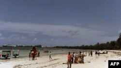 Local tourists walk at the Kenyatta public beach on August 30, 2012, in Mombasa, Kenya.