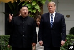 FILE - In this Feb. 28, 2019, file photo, U.S. President Donald Trump and North Korean leader Kim Jong Un take a walk after their first meeting at the Sofitel Legend Metropole Hanoi hotel, in Hanoi, Vietnam.