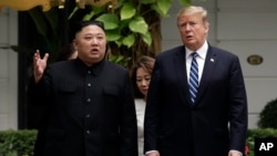 FILE - In this Feb. 28, 2019, file photo, U.S. President Donald Trump and North Korean leader Kim Jong Un take a walk after their first meeting at the Sofitel Legend Metropole Hanoi hotel, in Hanoi, Vietnam. 