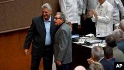 Cuba's President Miguel Diaz-Canel and former president Raul Castro, pose for a photo before the start of a session to debate the draft of a new Constitution, at the Convention Palace in Havana, Dec. 21, 2018.