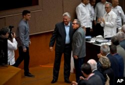 FILE - Cuba's President Miguel Diaz-Canel and former president Raul Castro, pose for a photo before the start of a session to debate the draft of a new Constitution, at the Convention Palace in Havana, Dec. 21, 2018.