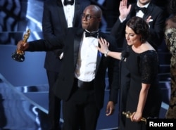 Director Barry Jenkins and producer Adele Romanski celebrating the best picture win for "Moonlight."